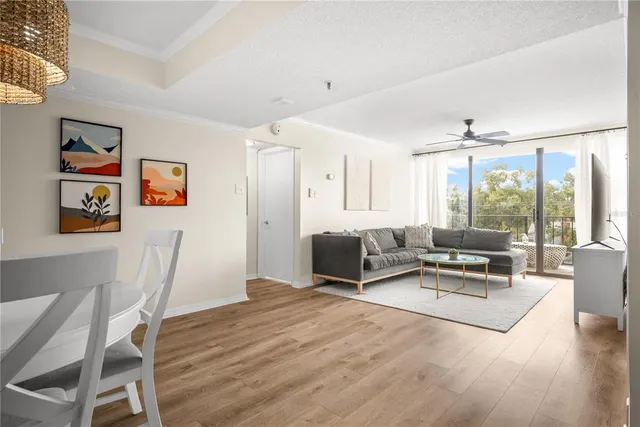 a living room with furniture a large window and gym equipment