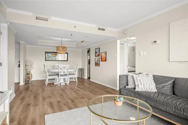 a living room with furniture and a dining table