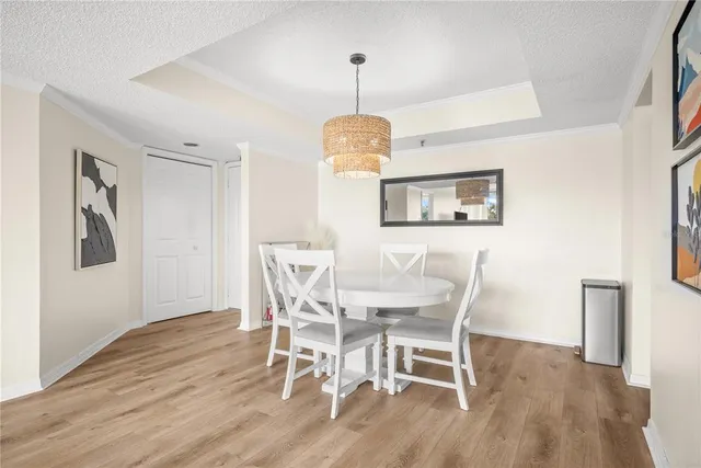 a dining room with furniture a window and wooden floor
