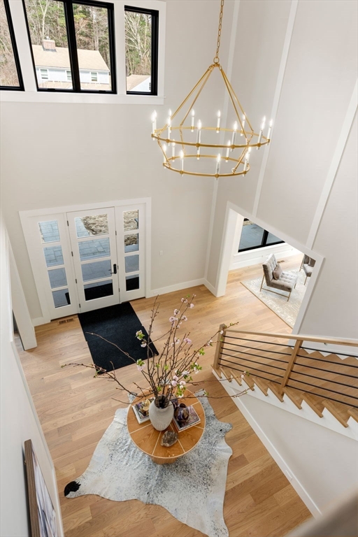 211 Stratford Road Needham, MA 02492 - Photo 17 of 32 a living room with furniture and a chandelier