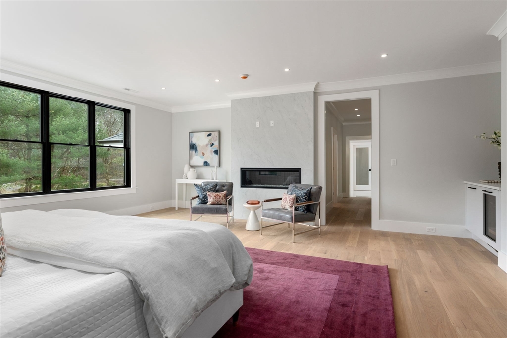 211 Stratford Road Needham, MA 02492 - Photo 19 of 32 a large bedroom with a bed and large window