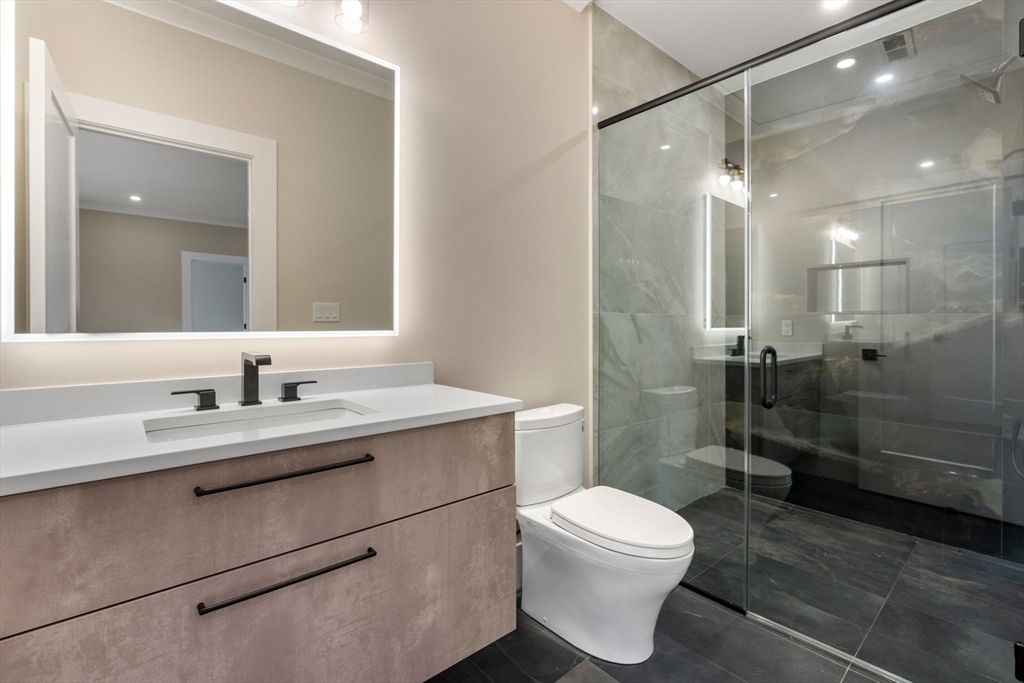 211 Stratford Road Needham, MA 02492 - Photo 28 of 32 a bathroom with a sink a toilet and shower