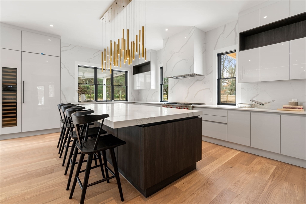 211 Stratford Road Needham, MA 02492 - Photo 7 of 32 a kitchen with a table chairs sink and cabinets