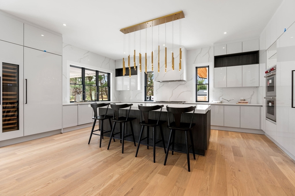 211 Stratford Road Needham, MA 02492 - Photo 8 of 32 a large kitchen with a table and chairs