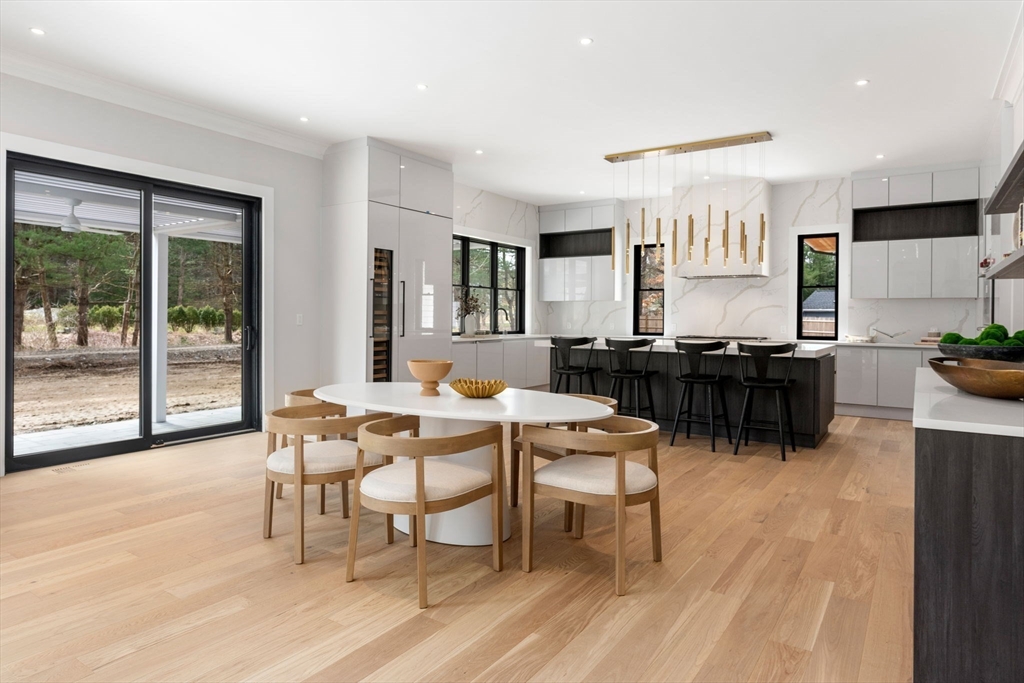 211 Stratford Road Needham, MA 02492 - Photo 9 of 32 a dining room with furniture and wooden floor