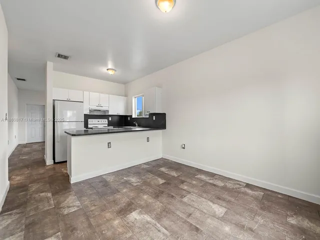 a kitchen with stainless steel appliances a refrigerator sink and microwave