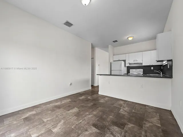 a view of a kitchen with stainless steel appliances