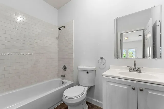 a bathroom with a granite countertop toilet a sink and a bathtub