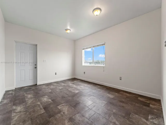 an empty room with a empty space and windows