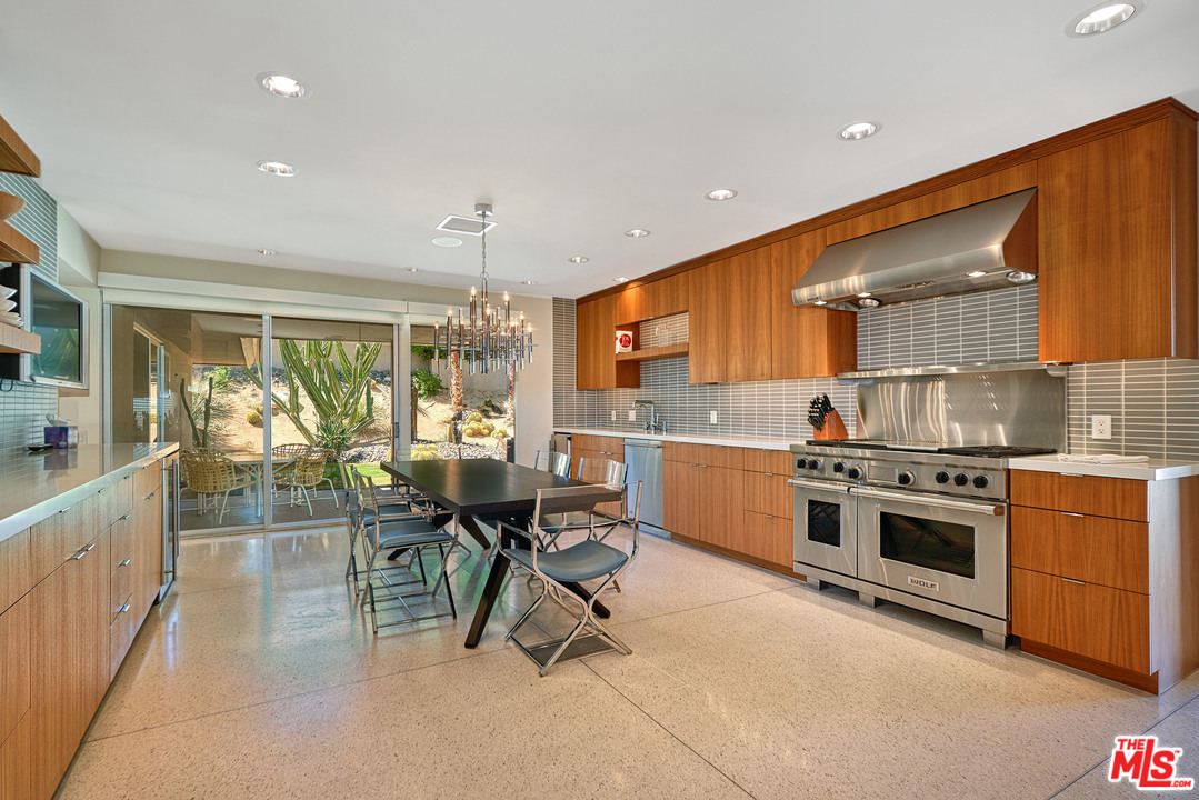70411 Pecos Road Rancho Mirage, CA 92270 - Photo 12 of 40 a kitchen with stainless steel appliances granite countertop sink stove top oven and cabinets