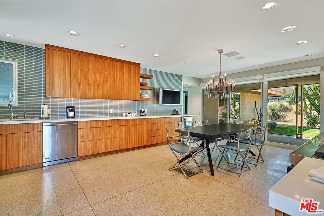70411 Pecos Road Rancho Mirage, CA 92270 - Photo 13 of 40 a kitchen with stainless steel appliances granite countertop sink stove and white cabinets with wooden floor