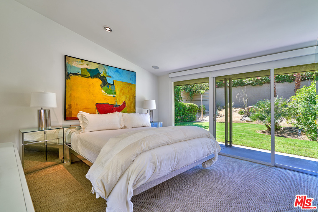 70411 Pecos Road Rancho Mirage, CA 92270 - Photo 14 of 40 a bedroom with a bed and a large window