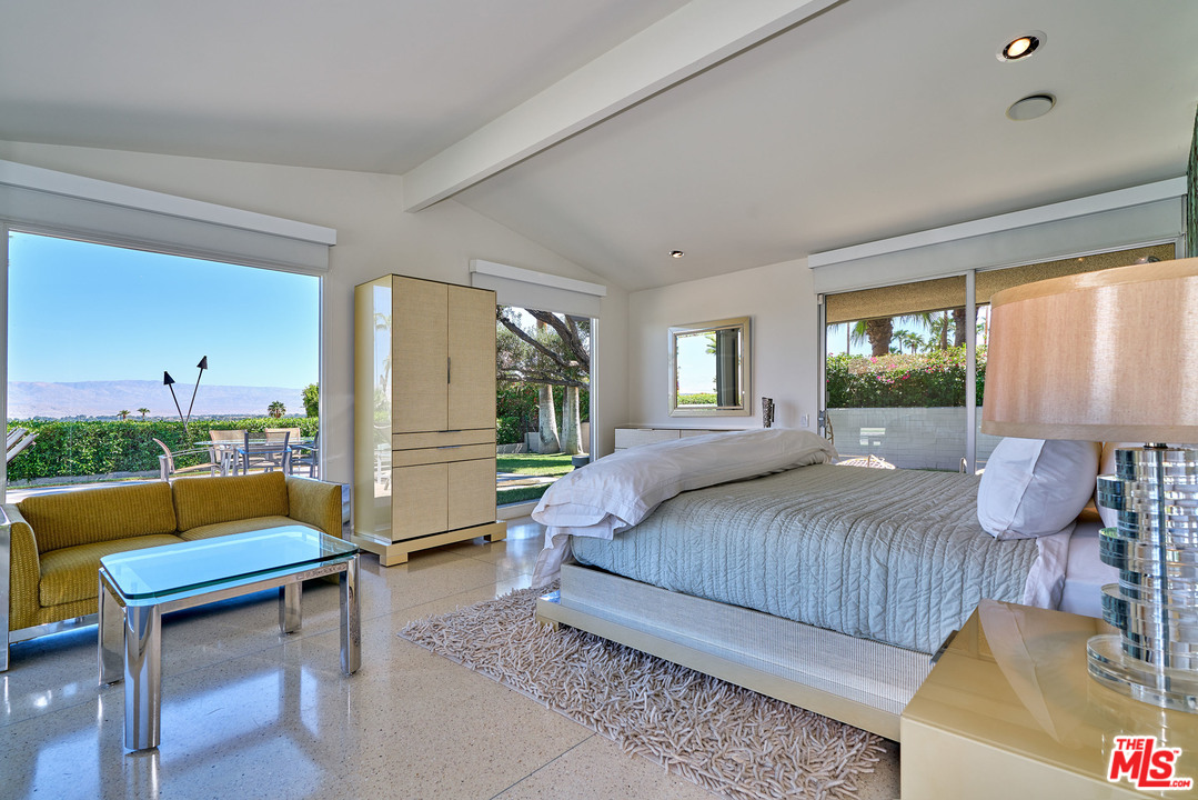 70411 Pecos Road Rancho Mirage, CA 92270 - Photo 22 of 40 a bedroom with a bed a chair and a couch