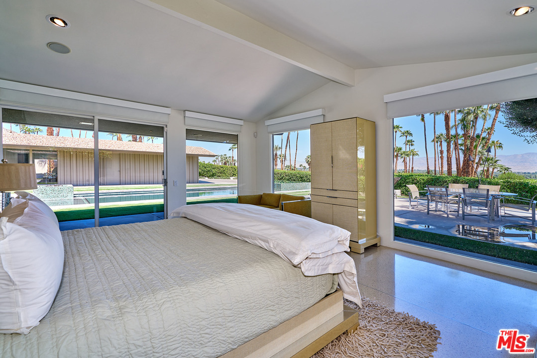 70411 Pecos Road Rancho Mirage, CA 92270 - Photo 24 of 40 a bed room with a bed and a large window