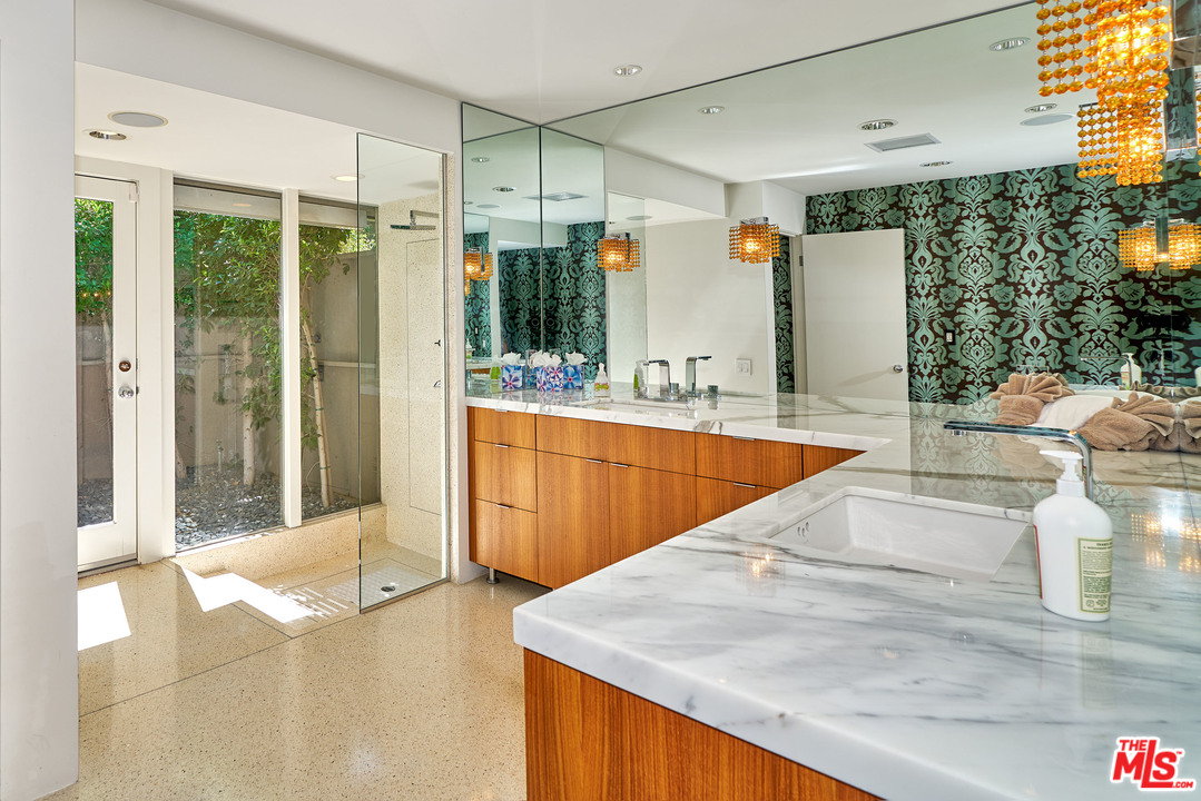 70411 Pecos Road Rancho Mirage, CA 92270 - Photo 25 of 40 a large white kitchen with kitchen island a large window a sink and stainless steel appliances