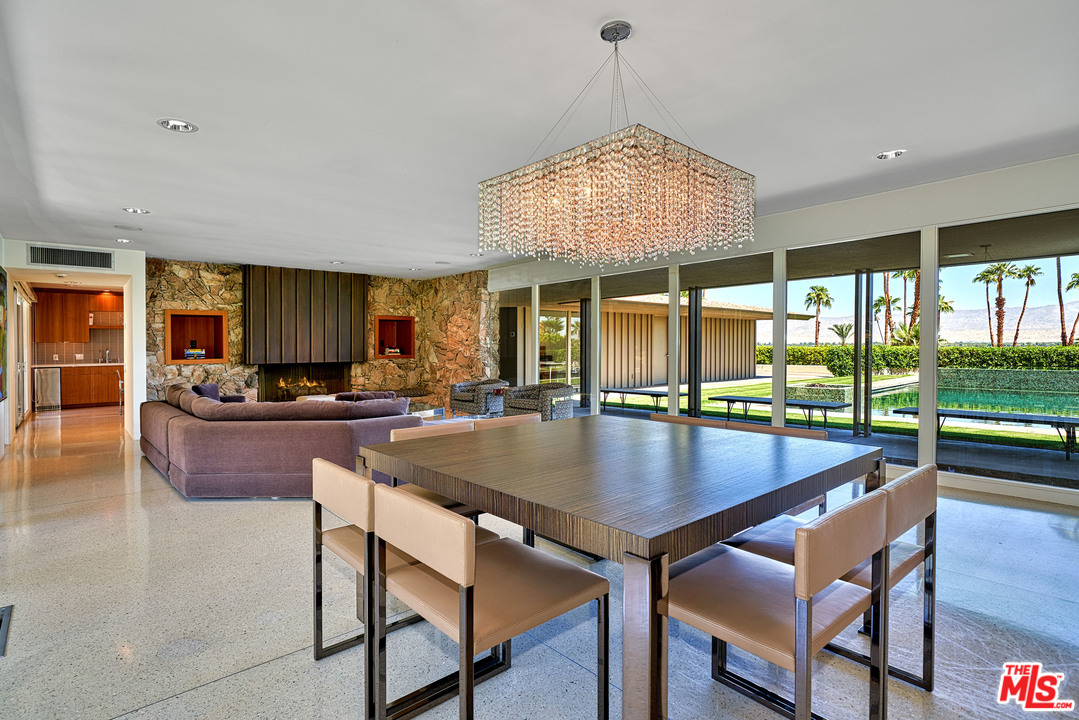 70411 Pecos Road Rancho Mirage, CA 92270 - Photo 6 of 40 an open kitchen with a table and chairs