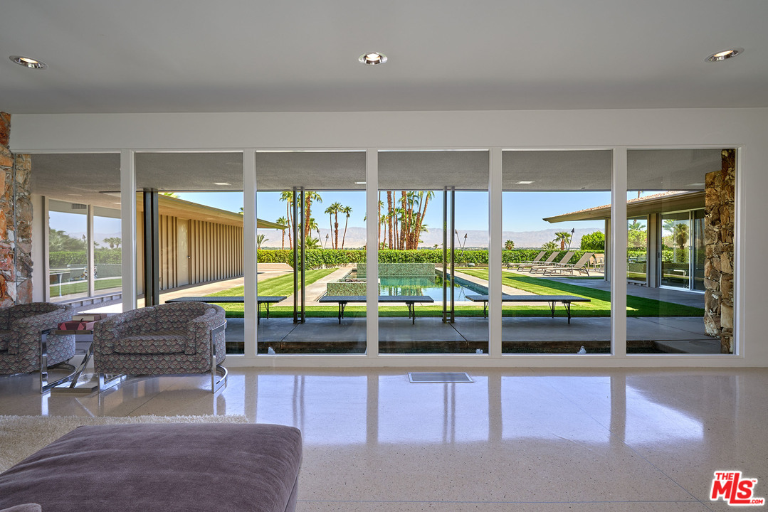 70411 Pecos Road Rancho Mirage, CA 92270 - Photo 9 of 40 a dining room with furniture and large windows