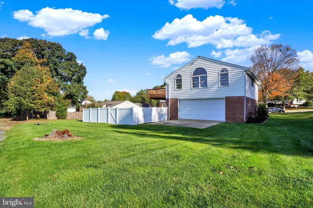 a view of a house with wooden fence