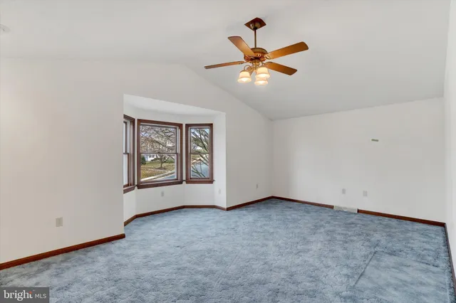 an aerial view of a house with a yard and lake view