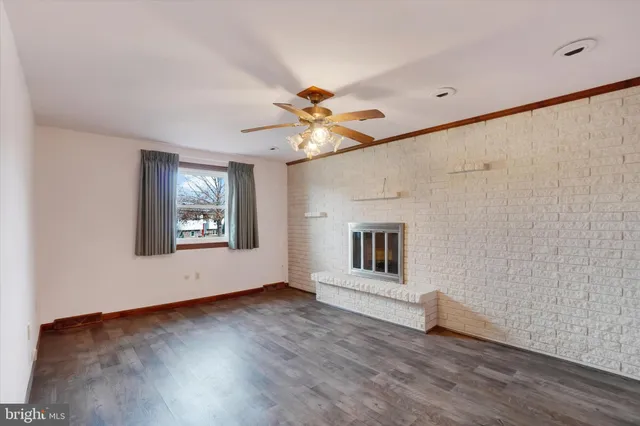 an aerial view of a house with a garden and lake view