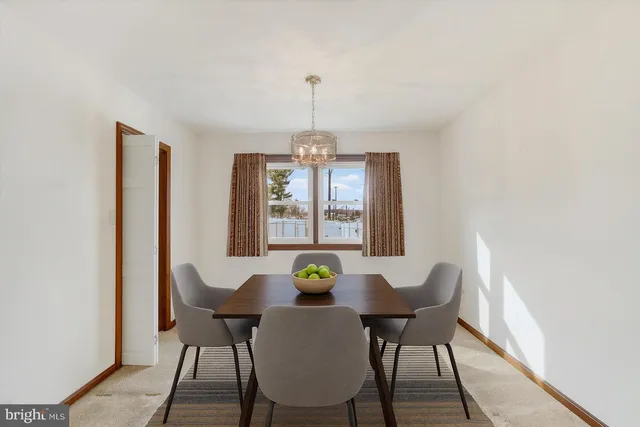 an empty room with windows and ceiling fan