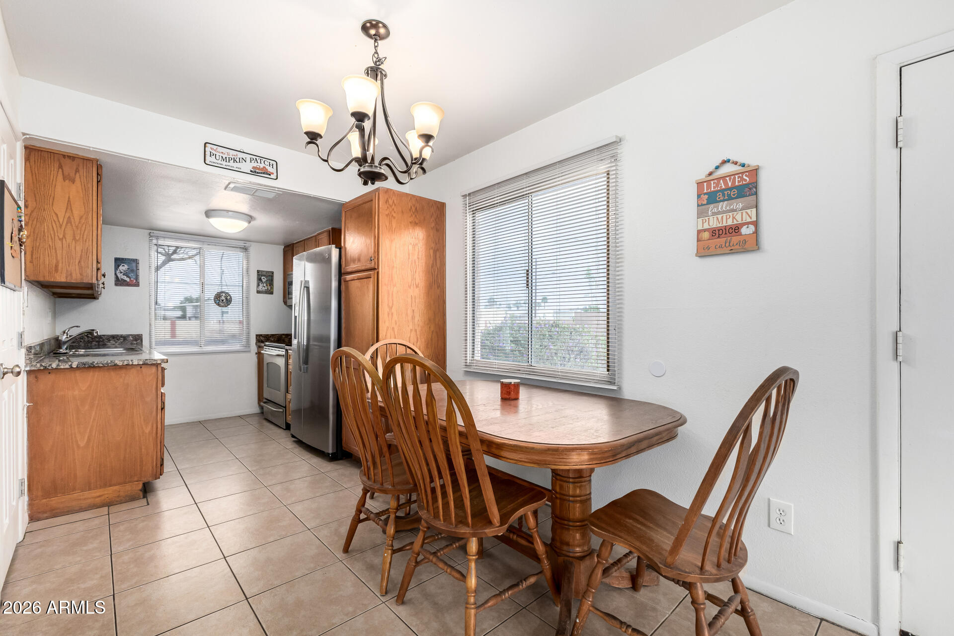 600 South Dobson Road, Unit 122 Mesa, AZ 85202 - Photo 3 of 28 a view of a dining room with furniture and a chandelier