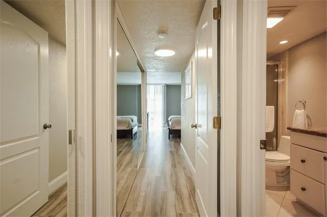 a bathroom with a granite countertop sink mirror vanity and toilet