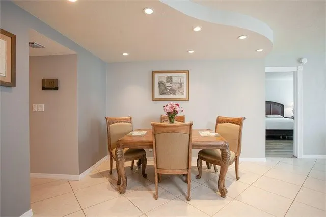 a kitchen with stainless steel appliances kitchen island granite countertop a refrigerator and a stove top oven