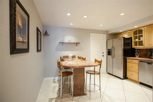 a kitchen with stainless steel appliances granite countertop a refrigerator and a stove
