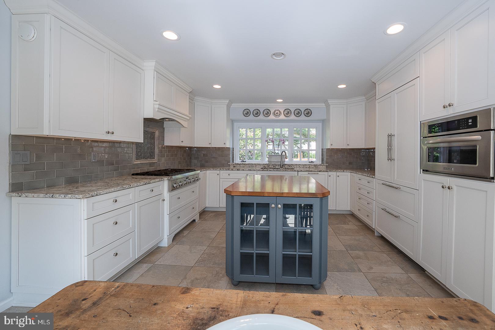 431 Waynesbrooke Road Berwyn, PA 19312 - Photo 16 of 63 a kitchen with stainless steel appliances kitchen island granite countertop a stove top oven a sink a counter space and cabinets