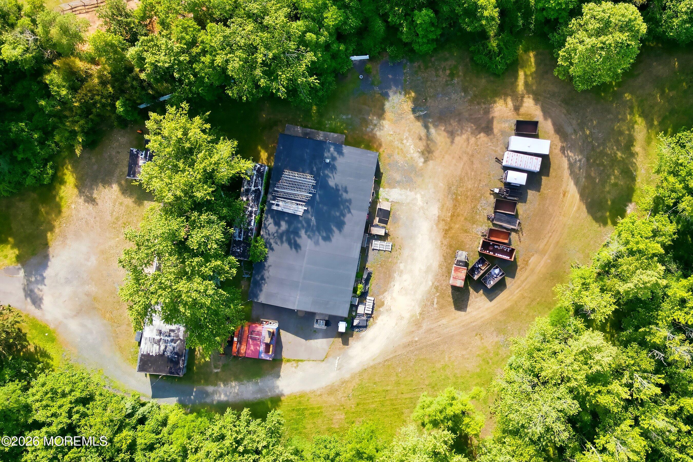 26 Megill Road Farmingdale, NJ 07727 - Photo 9 of 16 an aerial view of a house with a yard and large trees