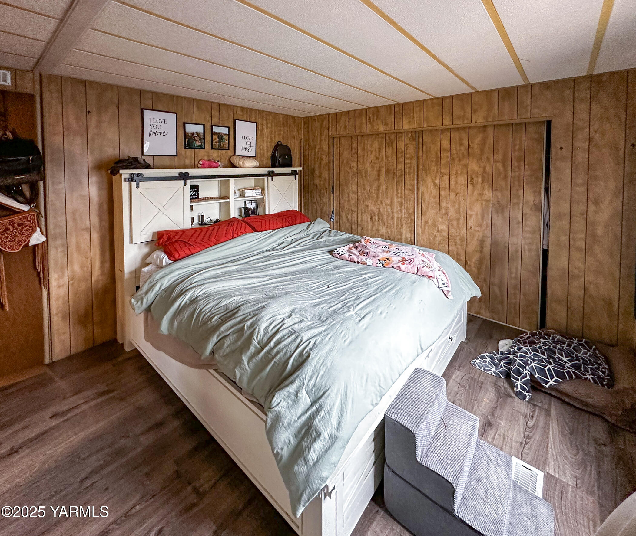 10 Wiland Heights Road Selah, WA 98942 - Photo 16 of 16 a bed sitting in a bedroom next to a cabinet