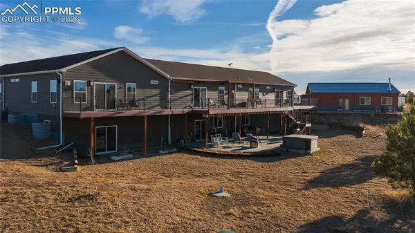 a front view of a house with sitting area