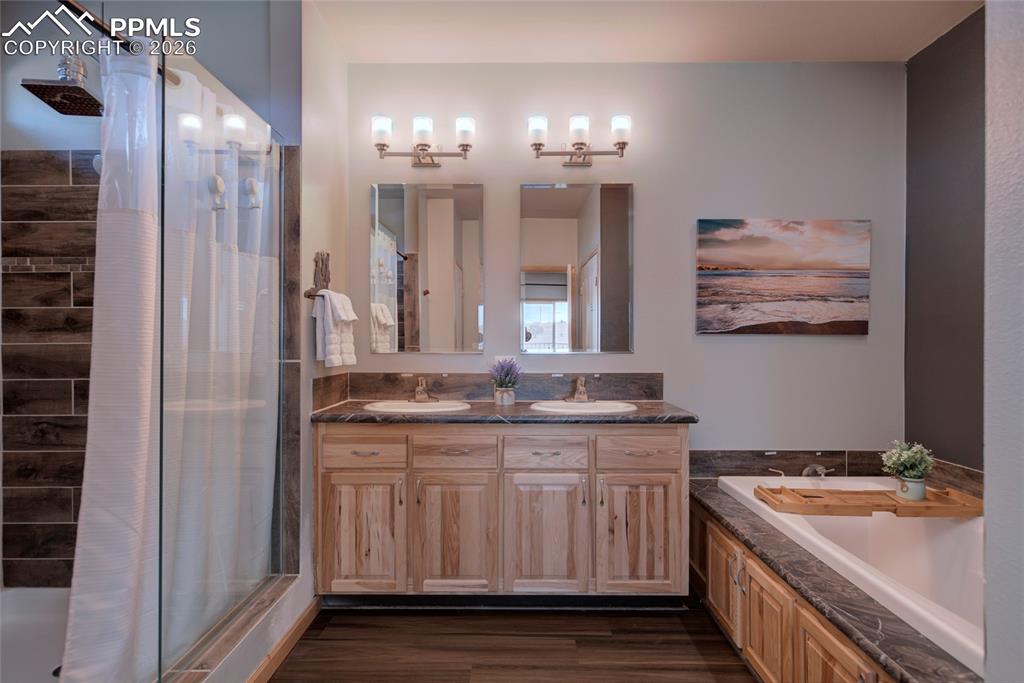 24965 Cave Spg Trail Elbert, CO 80106 - Photo 13 of 50 a bathroom with a granite countertop double vanity sink a vanity and a large mirror
