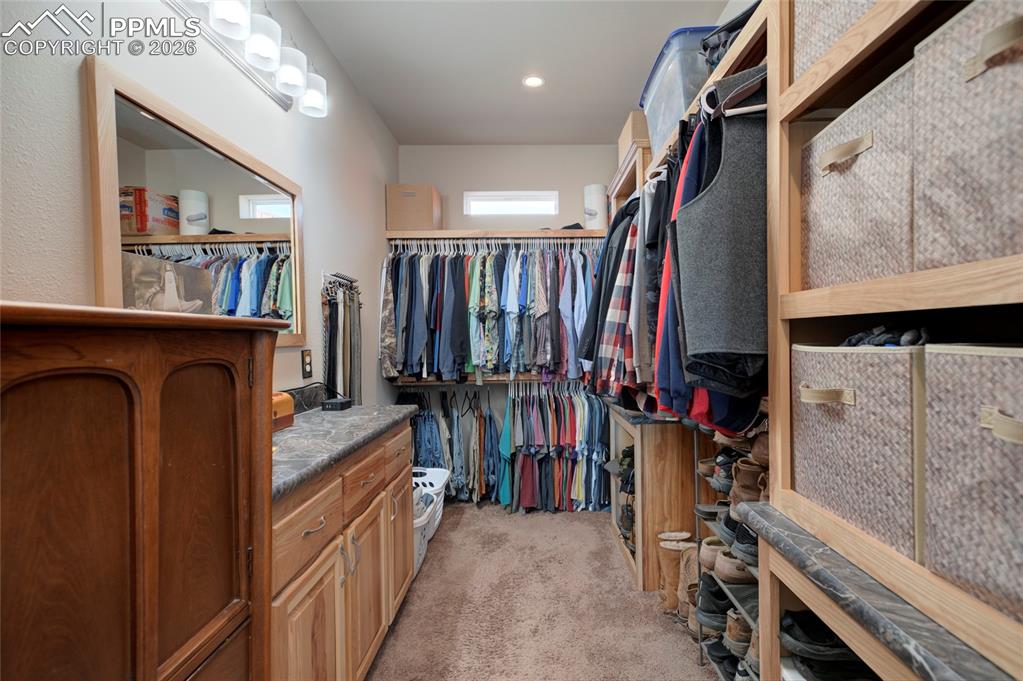 24965 Cave Spg Trail Elbert, CO 80106 - Photo 17 of 50 a view of walk in closet with clothes and shoes