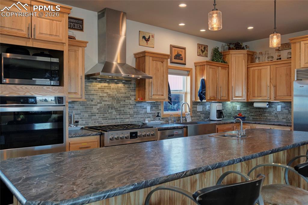 24965 Cave Spg Trail Elbert, CO 80106 - Photo 24 of 50 a kitchen with stainless steel appliances granite countertop a stove a sink and a microwave