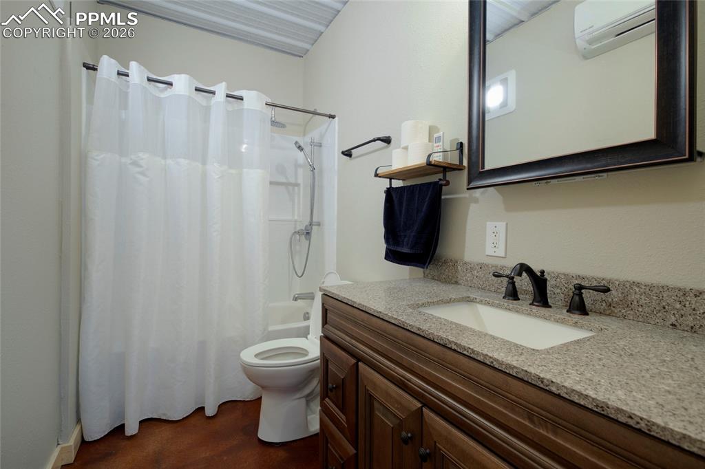24965 Cave Spg Trail Elbert, CO 80106 - Photo 25 of 50 a bathroom with a granite countertop sink toilet and a mirror