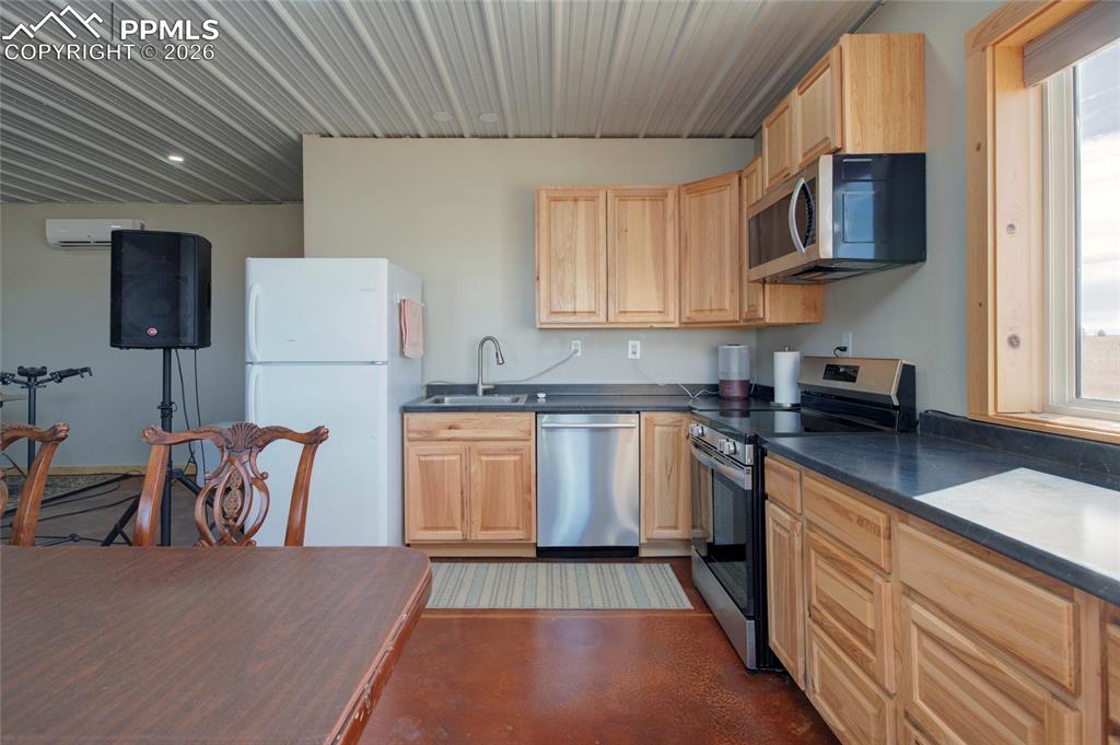 24965 Cave Spg Trail Elbert, CO 80106 - Photo 26 of 50 a kitchen with stainless steel appliances granite countertop a refrigerator sink and stove