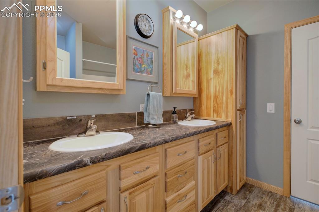 24965 Cave Spg Trail Elbert, CO 80106 - Photo 8 of 50 a bathroom with a granite countertop sink and a mirror
