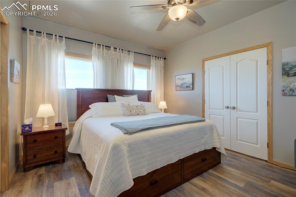 24965 Cave Spg Trail Elbert, CO 80106 - Photo 9 of 50 a bedroom with a bed and a chandelier
