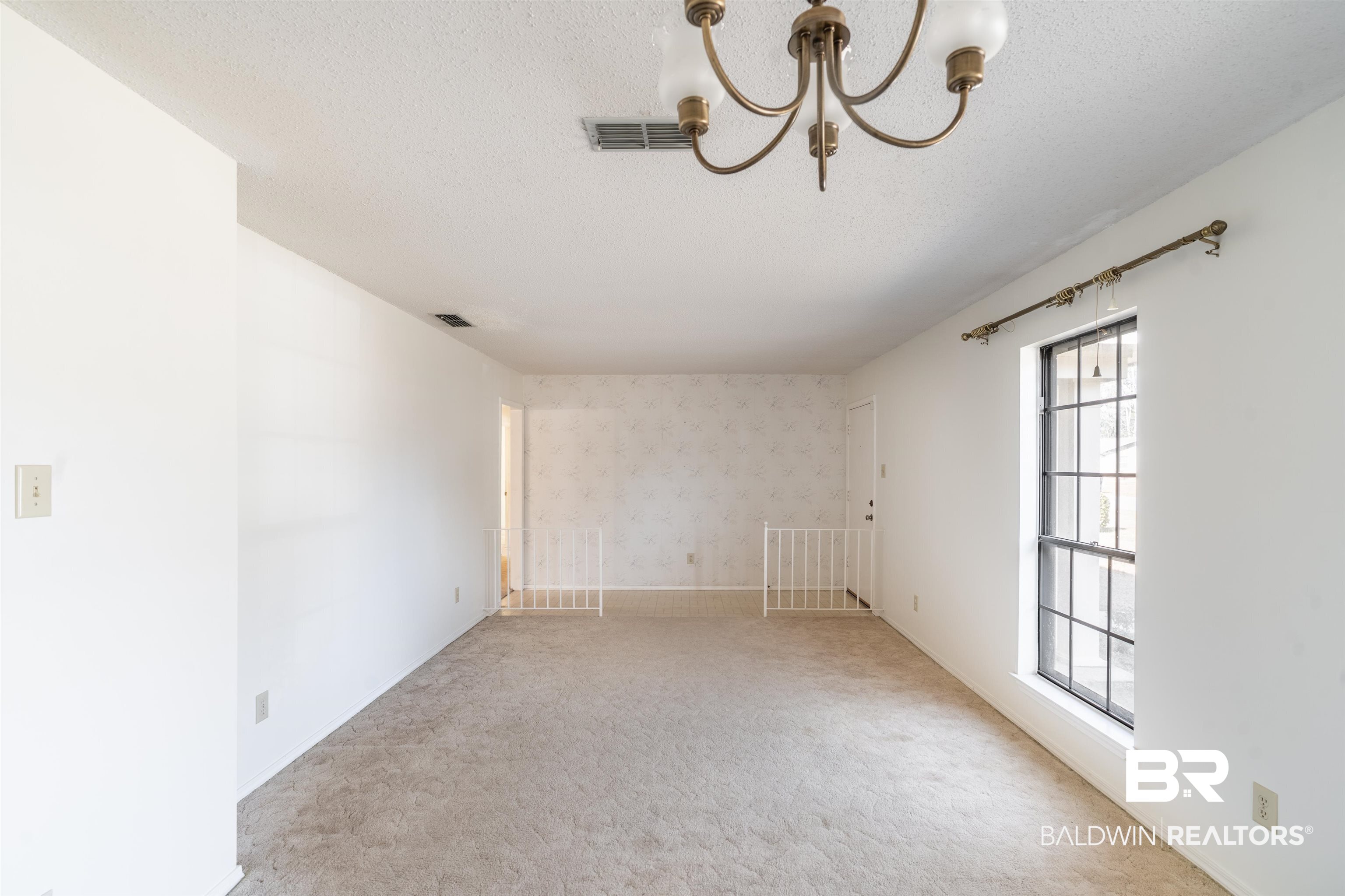 9751 Pine Knoll Road Mobile, AL 36608 - Photo 3 of 36 Carpeted empty room with suspended lighting, wallpapered walls, and a textured ceiling