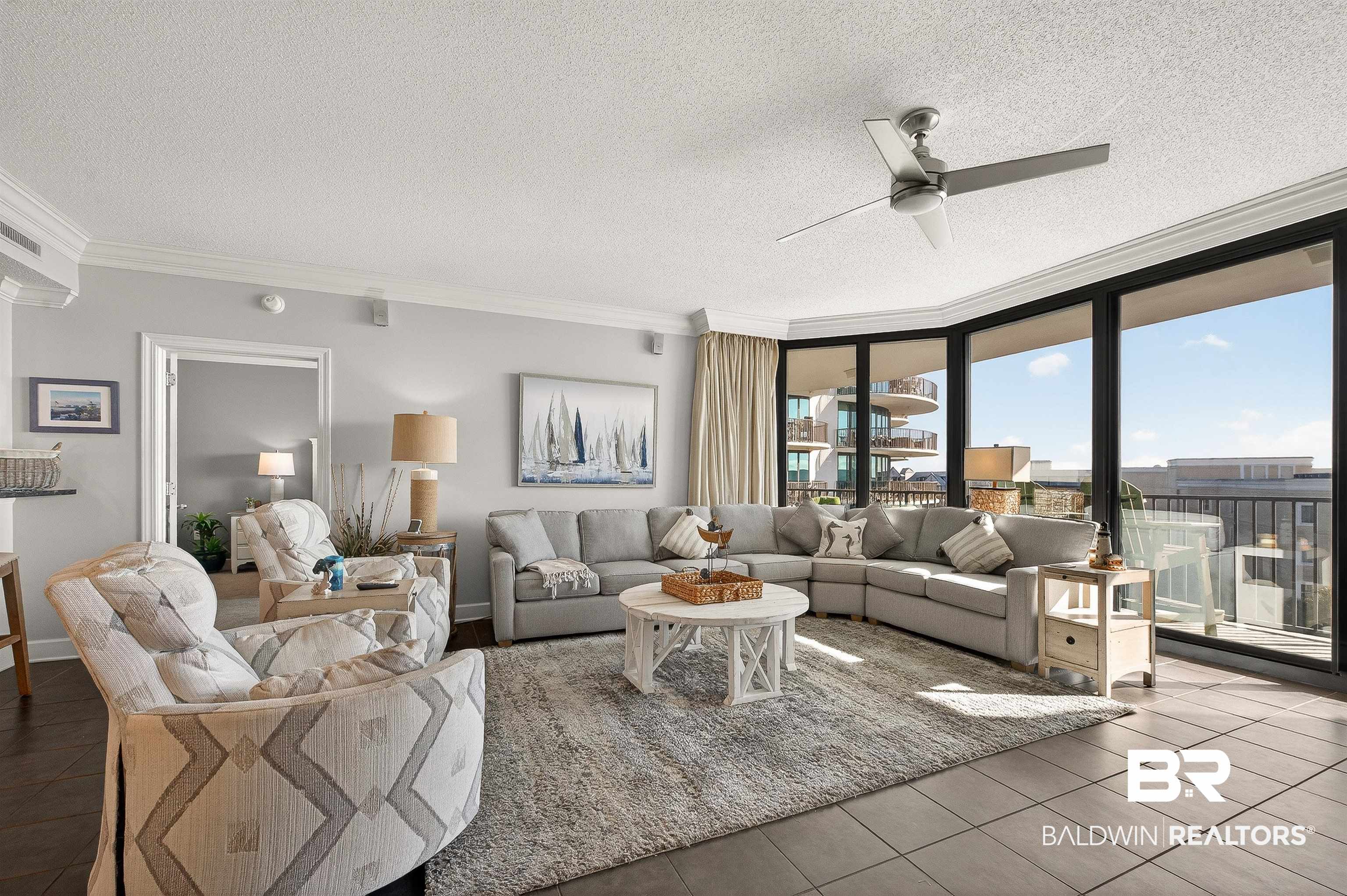 27582 Canal Road, Unit 2507 Orange Beach, AL 36561 - Photo 12 of 75 Living area featuring ornamental molding, a textured ceiling, floor to ceiling windows, and ceiling fan