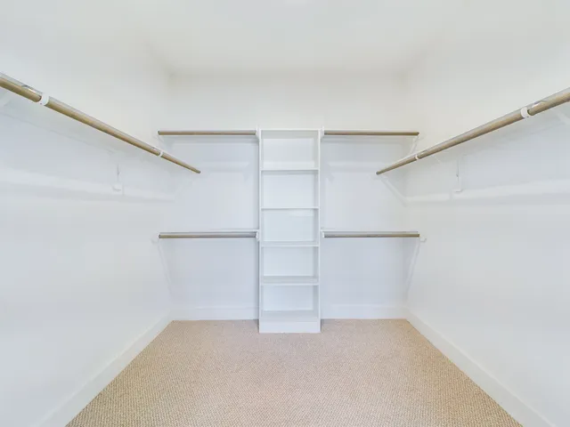 a open dining room with stainless steel appliances kitchen island granite countertop a table chairs and a refrigerator