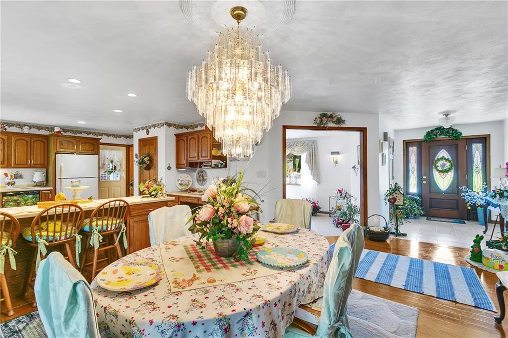 111 Francis Road Pittsburgh, PA 15239 - Photo 3 of 23 a view of a dining room with furniture a chandelier and wooden floor