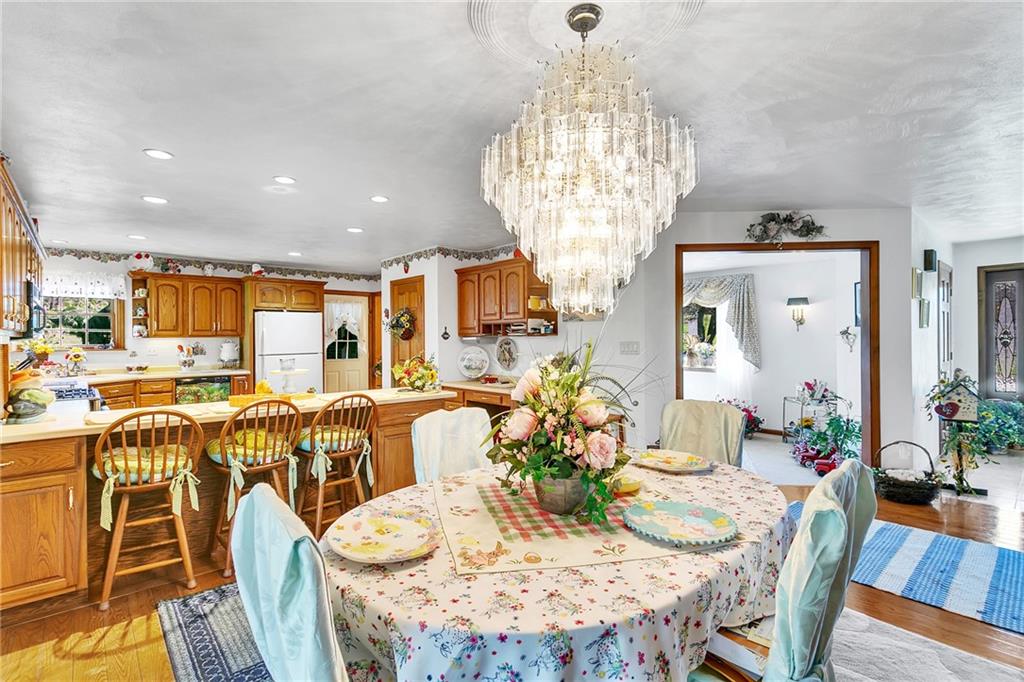 111 Francis Road Pittsburgh, PA 15239 - Photo 4 of 23 a view of a dining room with furniture a chandelier and wooden floor