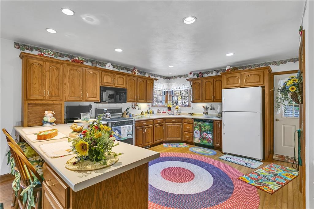 111 Francis Road Pittsburgh, PA 15239 - Photo 5 of 23 a kitchen with a refrigerator and a stove top oven