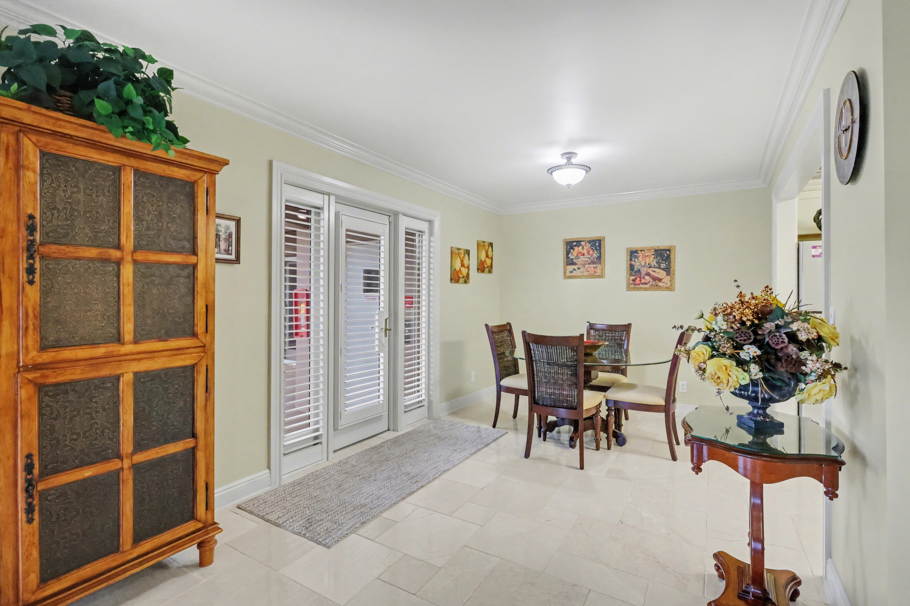 129 South Golfview Road, Unit 2 Lake Worth Beach, FL 33460 - Photo 12 of 35 a view of a dining room with furniture and a potted plant