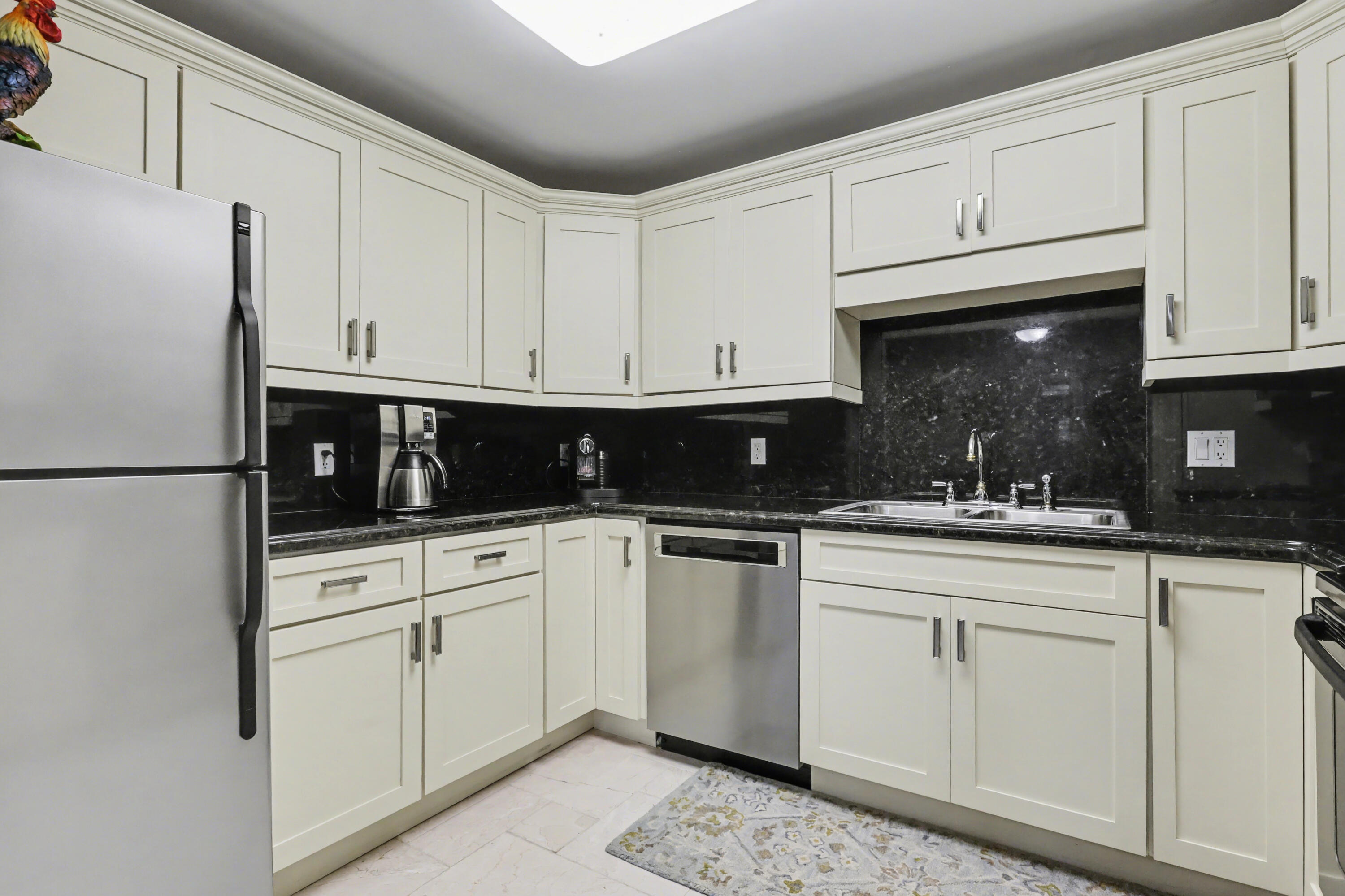129 South Golfview Road, Unit 2 Lake Worth Beach, FL 33460 - Photo 16 of 35 a kitchen with white cabinets and white appliances