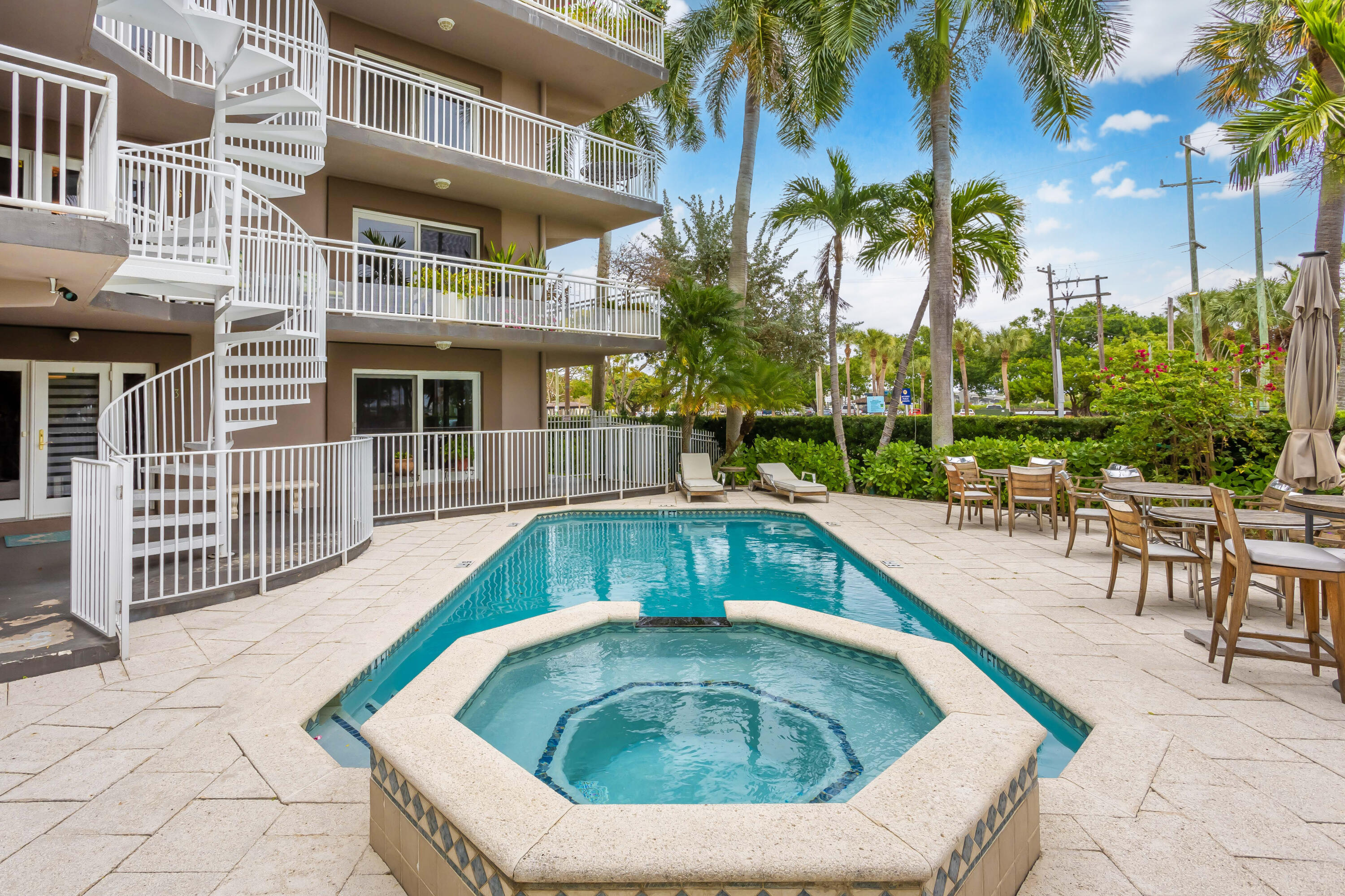 129 South Golfview Road, Unit 2 Lake Worth Beach, FL 33460 - Photo 2 of 35 a swimming pool with outdoor seating and yard