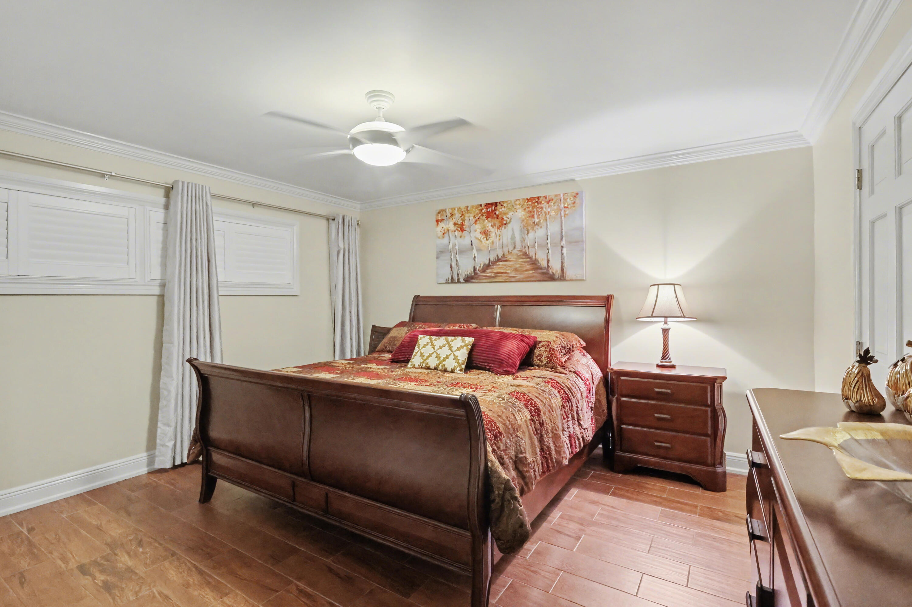 129 South Golfview Road, Unit 2 Lake Worth Beach, FL 33460 - Photo 21 of 35 a bedroom with a bed and a chandelier